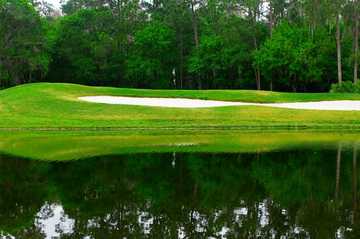 A view over the water of green at The Golf Club of Cypress Creek